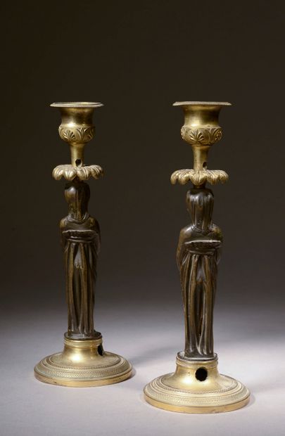 null Pair of small bronze torches with brown patina and gilt, the shaft with caryatid...