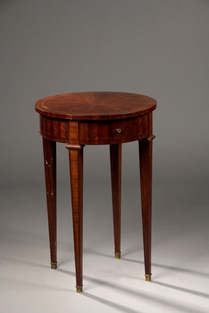  A high rosewood veneer table with radiating patterns on the top and chevrons on...