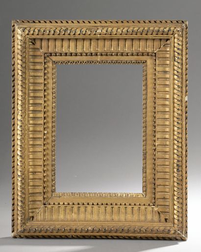  Wooden frame with canals and interlacing and gilded composition (small lacks). 19th...