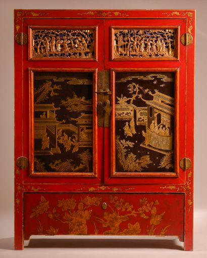 null A carved, polychromed and gilded wooden cabinet opening with a flap at the bottom...