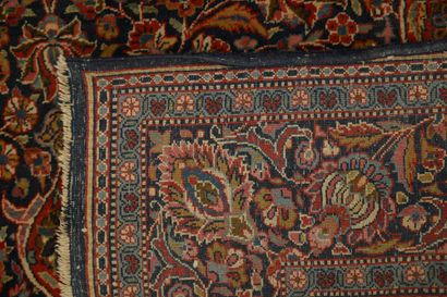 null Fine wool carpet with a midnight blue background decorated with floral scrolls,...