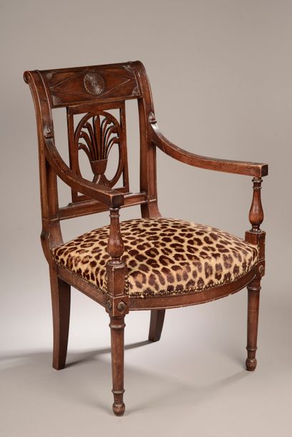 null A mahogany and mahogany veneer armchair, the back slightly overturned with a...