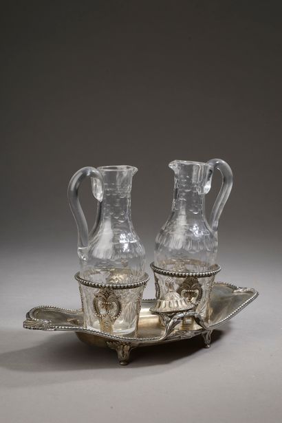 null A silver oil and vinegar cruet, the edges decorated with a net of pearls, the...