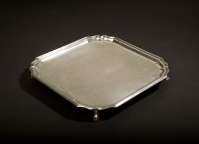 null Silver card tray of square shape with cut and contoured sides resting on four...