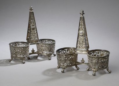 null AUCOC.

A pair of silver double saltshakers, the cups decorated with medallions,...