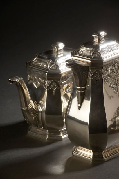 null A silver tea and coffee set with Regency style decoration of ironwork, foliage...