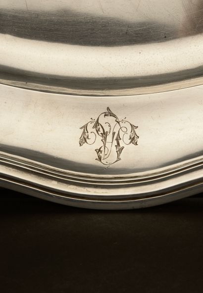 null Large oval silver dish, the wing with eight contours punctuated with leafy clasps....