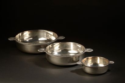 null Three silver plated ear bowls, two lined with gadroons, the handles showing...