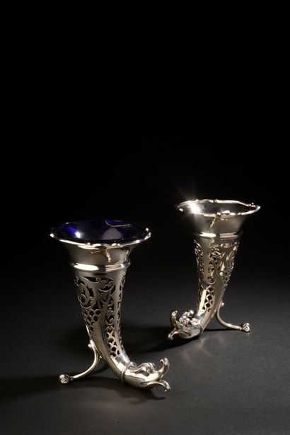 null A pair of silver tripod rhyton vases, the rim scalloped, the body with openwork...