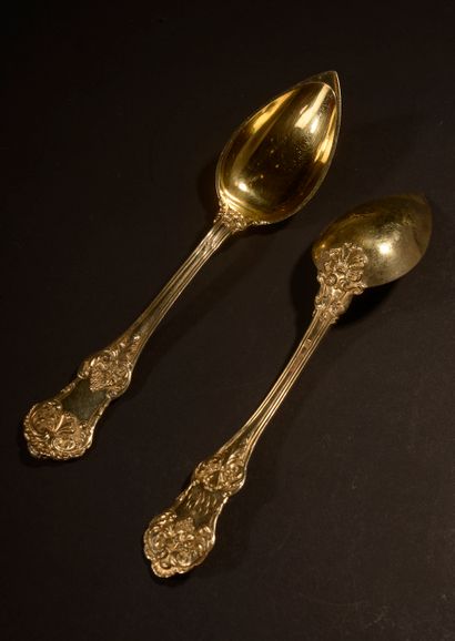 null Set of eighteen silver gilt spoons, the spatula decorated with pampers, shells...