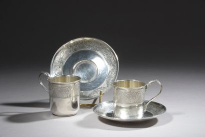 null Pair of silver cups and their saucers with engraved decoration of foliage bands....
