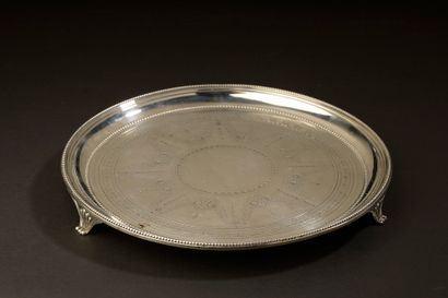 null A small tripod silver circular tray, the basin engraved with festooned garlands...