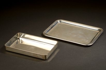 null Two rectangular silver trays (two sizes). The smaller one engraved in its center...
