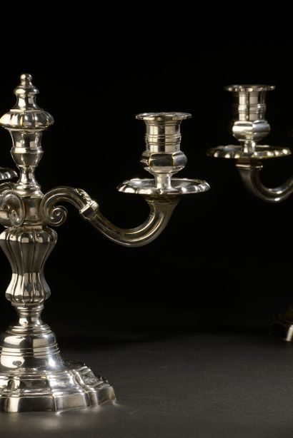 null A pair of silver plated bronze candelabras with three arms of light, the circular...