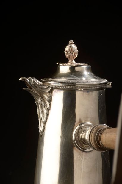 null A slightly truncated cone-shaped silver jug, the spout forming an eagle's head...