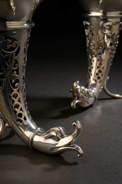null A pair of silver tripod rhyton vases, the rim scalloped, the body with openwork...