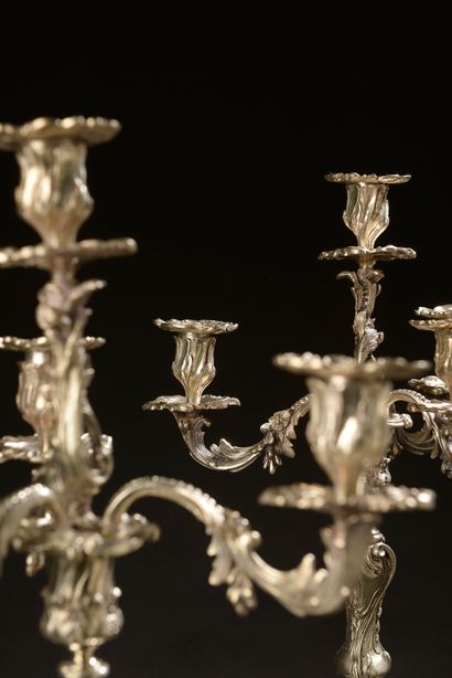 null Pair of silver plated candelabras decorated with interlacing foliage and flowers,...