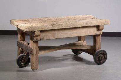 null Stripped solid wood workbench forming a coffee table resting on three casters.

Height...