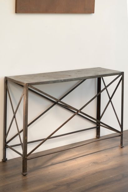 null Metal console resting on four straight braced legs. The sides are reinforced...