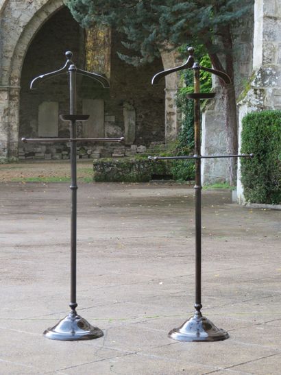 Pair of metal valets with a brown patina...