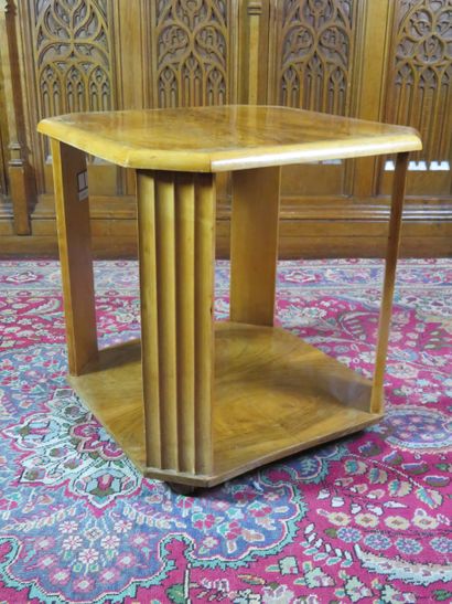 An octagonal pedestal table in light natural...