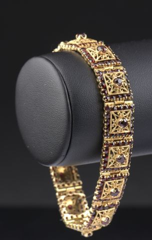 null 18k yellow gold bracelet composed of fourteen square links adorned with faceted...
