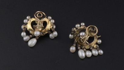 null Pair of 18k yellow gold ear clips set with a round pearl, probably fine, surrounded...