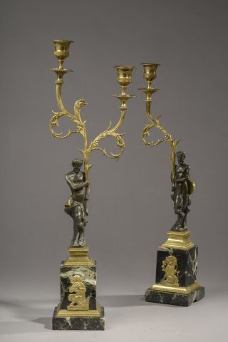 null Pair of torches with two arms of light, the shaft formed by a faun in patinated...