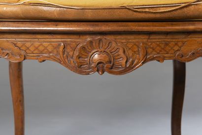 null Two caned armchairs in molded and carved beech, resting on four cambered legs,...