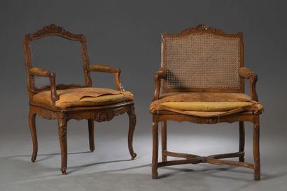 null Two caned armchairs in molded and carved beech, resting on four cambered legs,...