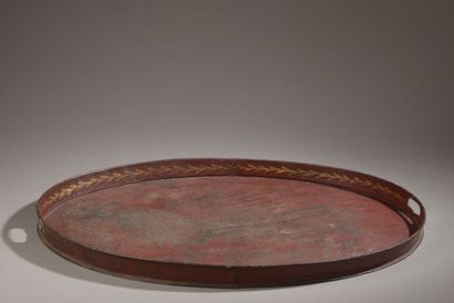Oval tray in red lacquered sheet metal, the...