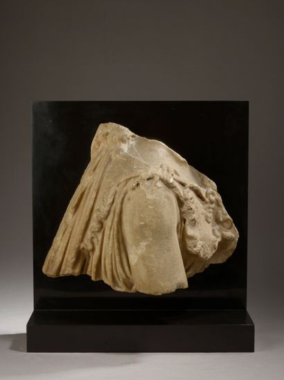 null 
Fragmentary marble relief representing the right shoulder of Athena dressed...