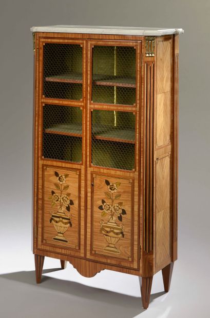 null Bookcase in rosewood and amaranth veneer opening to two doors, the lower part...