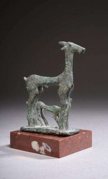 null 
Bronze group representing a doe and a fawn on a rectangular openwork base....