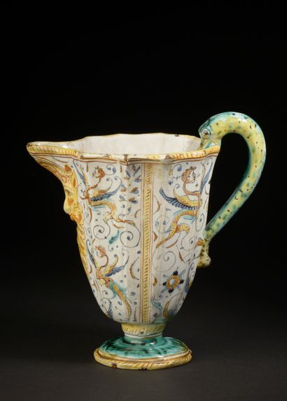 null Ewer with cut sides in majolica, the handle in the shape of snake, the spout...