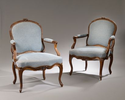 null Two large armchairs with flat backs in walnut and molded beech, carved with...