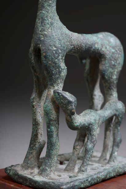 null 
Bronze group representing a doe and a fawn on a rectangular openwork base....