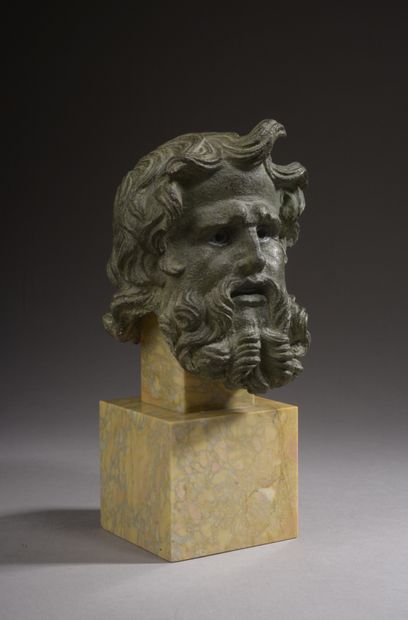 null 
Head of a bearded deity (Poseidon or triton?) in bronze. The hair and the beard...