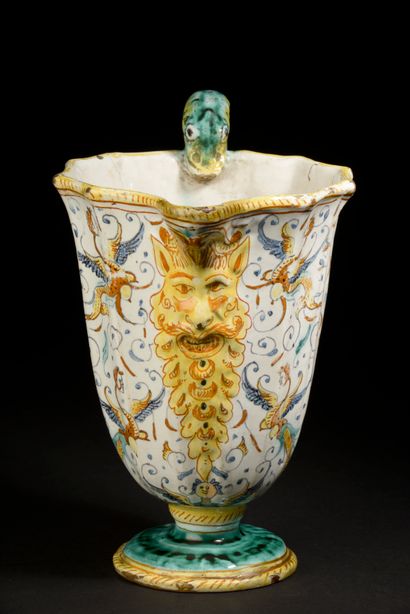 null Ewer with cut sides in majolica, the handle in the shape of snake, the spout...