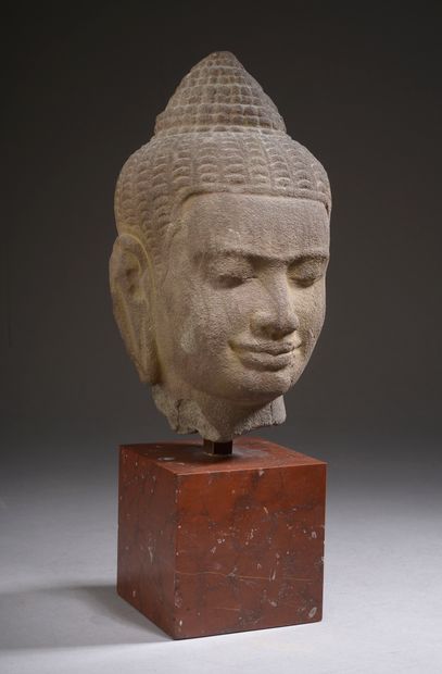 null 
Head of Buddha in grey sandstone, eyes half closed, sketching a slight smile,...