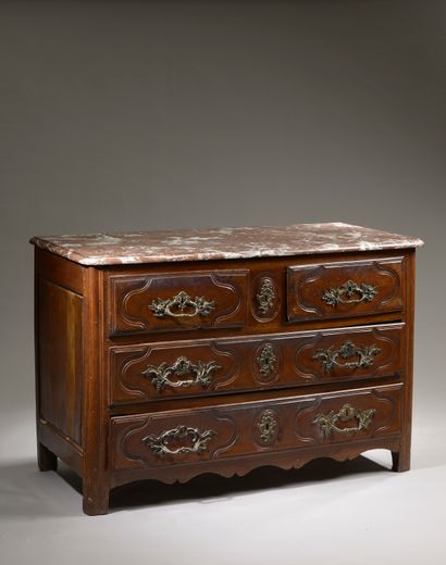 null Molded walnut chest of drawers, the front slightly curved opening to four drawers...