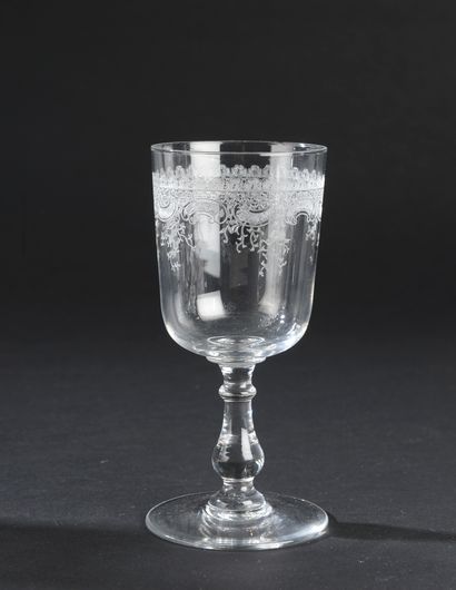 null Suite of twelve blown crystal stemmed glasses, the cup engraved with a lace...