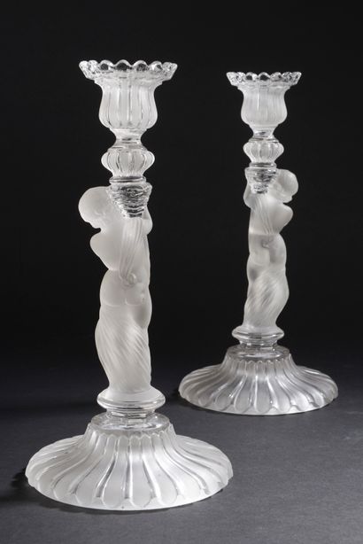 null Pair of girandoles or torches in clear molded crystal and satin, the shaft representing...