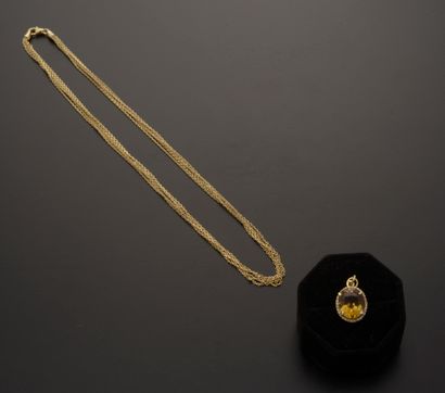 null 18k yellow gold pendant presenting an oval citrine in a modern brilliant-cut...