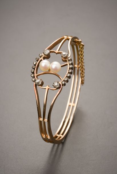 null Rigid bracelet in 18k pink gold, silver 800 thousandths with a central motif...