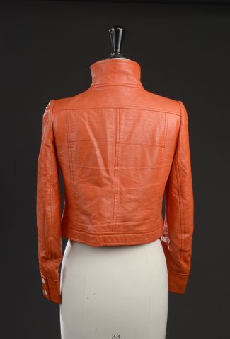 null COURRÈGES.

Orange vinyl jacket, high collar, straight and short silhouette,...