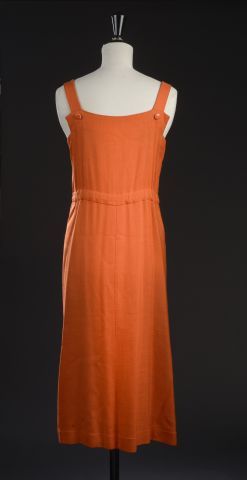 null COURRÈGES. 

Long dress in orange linen rayon, with straps, V-neck closed with...