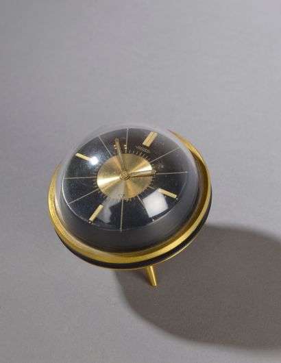 null JAEGER.

Desk clock in black composition and gilded brass of ball form resting...