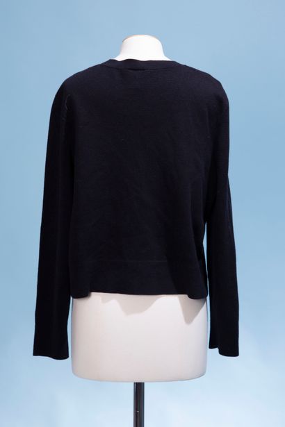null CHANEL Uniform. 

Black wool and cotton blend cardigan, the round neck, closed...