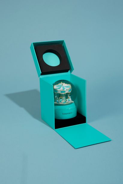 null TIFFANY CO. 

Glass snow globe on a sky-blue lacquered plastic base featuring...